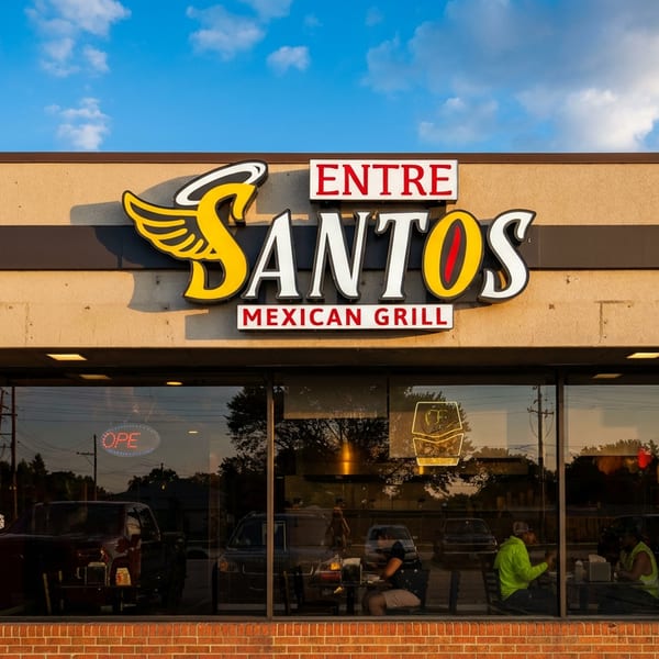 Entre Santos Mexican Grill storefront with a prominent sign and customers visible inside.